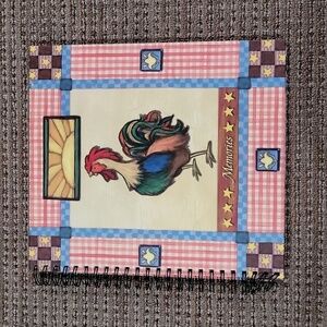 Martin Designs spiral scrapbook filled with white paper with Rooster design
